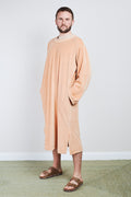 Man in sand Sonus Aeris one-piece against light background